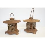 A 20th century pair of cast iron garden/patio lanterns in the Chinese pagoda style, each lantern