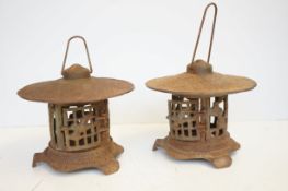 A 20th century pair of cast iron garden/patio lanterns in the Chinese pagoda style, each lantern