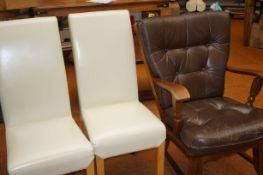 Two modern dining chairs together with a leather a