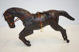 A leather horse, 37cm wide