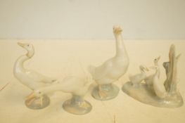 Two Lladro swans together with two nayo