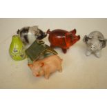 A collection of studio ceramic pigs