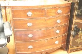 A Georgian two over three chest of drawers bow fronted