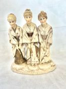 Group figure of three ladies wearing traditional o