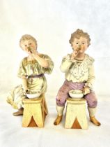 A pair of bisque figures, young girl & young boy s