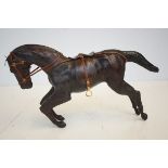 A leather horse, 37cm wide