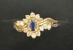 Diamond & sapphire ring set with 13 diamonds surro