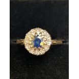 9ct Gold ring set wth central sapphire surrounded