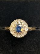 9ct Gold ring set wth central sapphire surrounded