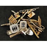 A collection of cuff links and tie pins