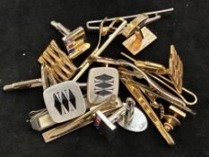 A collection of cuff links and tie pins