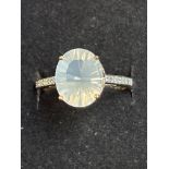 9ct gold ring set with large white gemstone and 6