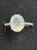 9ct gold ring set with large white gemstone and 6
