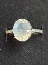 9ct gold ring set with large white gemstone and 6