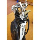 Set of Ping golf clubs, four putters and a Titleis