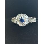 9ct White gold ring central sapphire surrounded by