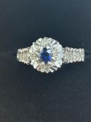9ct White gold ring central sapphire surrounded by