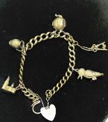 Yellow metal charm bracelet with five 9ct gold cha