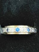 9ct Gold eternity ring set with blue & white stone