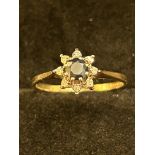 9ct Gold ring set wth central sapphire surrounded