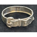 Silver bangle in form of a belt with safety chain