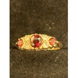 9ct Gold ring set with 3 garnets & 4 white stones