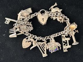 Silver charm bracelet - 18 charms