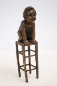 Bronze boy on chair signed
