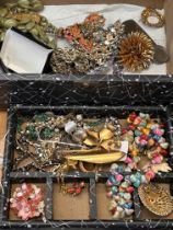 Unsorted box of costume jewellery to include watch