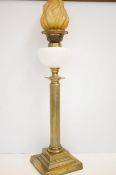 Early brass column oil lamp with milk glass reserv