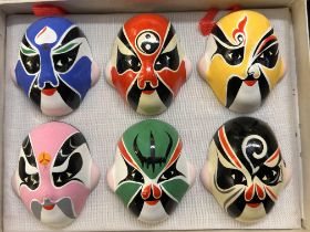 Chinese decorative opera masks in a small case