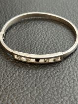 Silver bangle 4 clear & 1 black stone