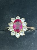 9ct Gold ring set with central red stone surrounde