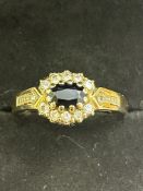 9ct Gold ring set with diamond & central blue ston
