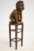 Bronze child on chair signed