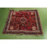A small red ground wool rug