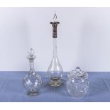 Two carafes one with silver collar and a lidded jar