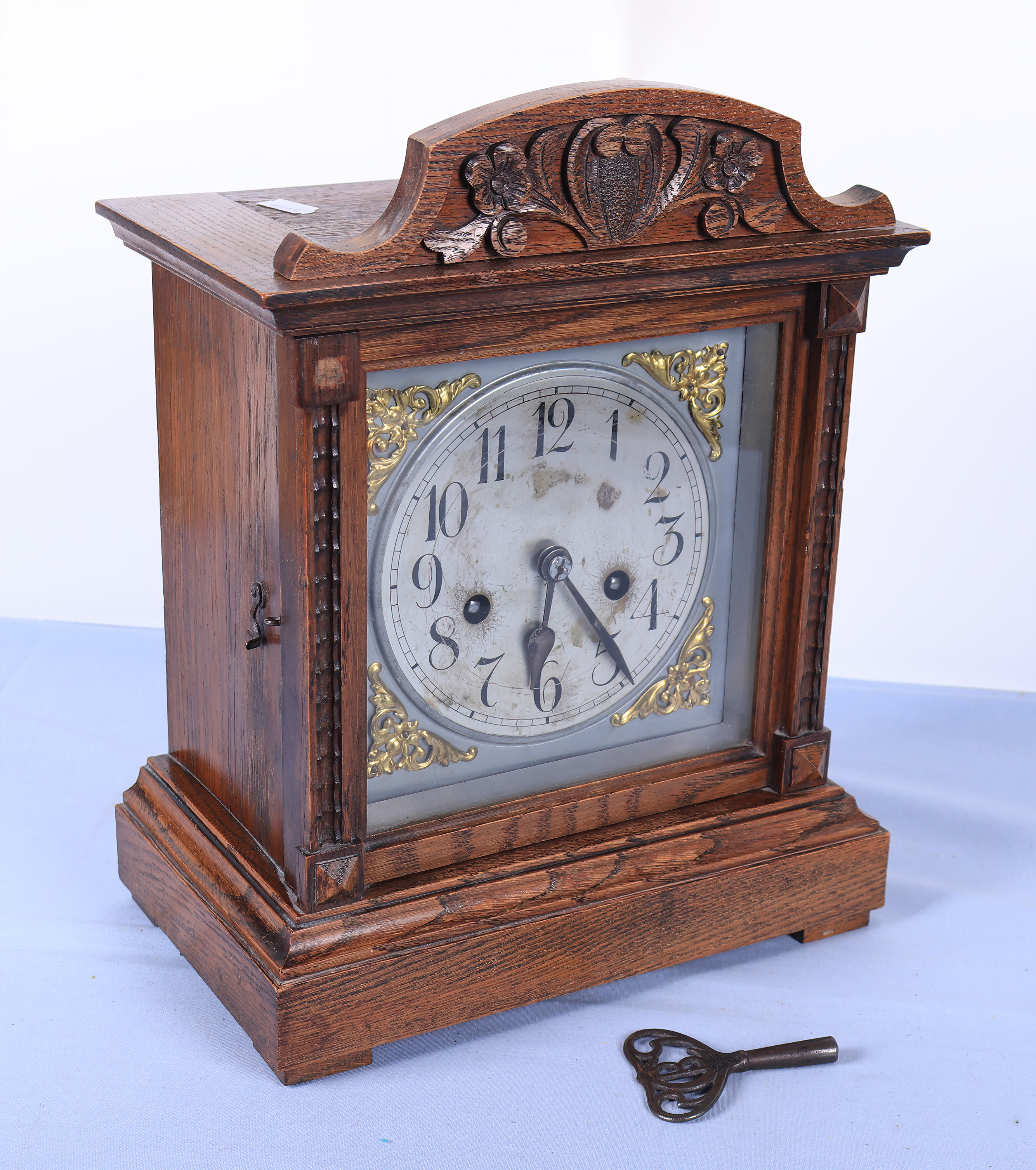 A small carved oak mantel clock