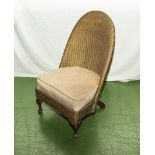 A vintage Lloyd Loom style cane nursing chair