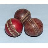 Three vintage cricket balls