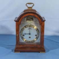 A John Morley reproduction broken arched top bracket clock with gilt and silvered dial.