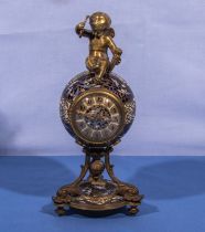 A small cloisonné clock with cherub 21cm