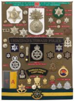 49 Trinidad and Tobago military and police badges etc. Board with good display of metal and cloth