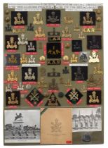 62 King's African Rifles badges etc. Board with good display of metal and cloth badges, buttons etc.