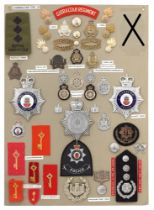 46 Gibraltar military and police badges etc. Board with good display of metal and cloth badges,