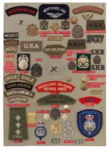 52 Newfoundland, St. Helena & Falklands badges etc. Board with good display of metal and cloth