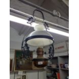 A vintage brass ceiling oil lamp with milk glass shade Location: RAB