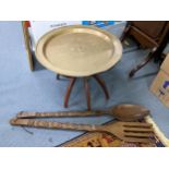 A vintage brass tray topped folding occasional table together with treen African oversized fork