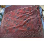 A Persian hand woven red ground rug decorated with elephant gulls, multiguard border and tasselled