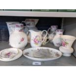 A selection of mainly Coalport porcelain to include a set of four 'The Caughley Mask-Head' jugs,